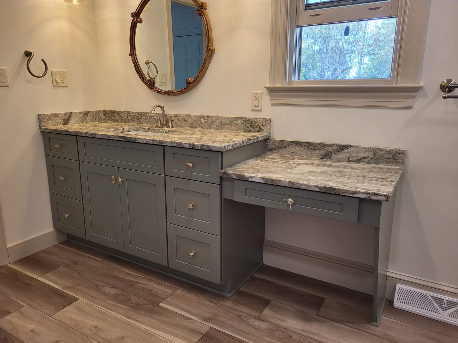 Gray vanity with granite top and accessible lowered sink