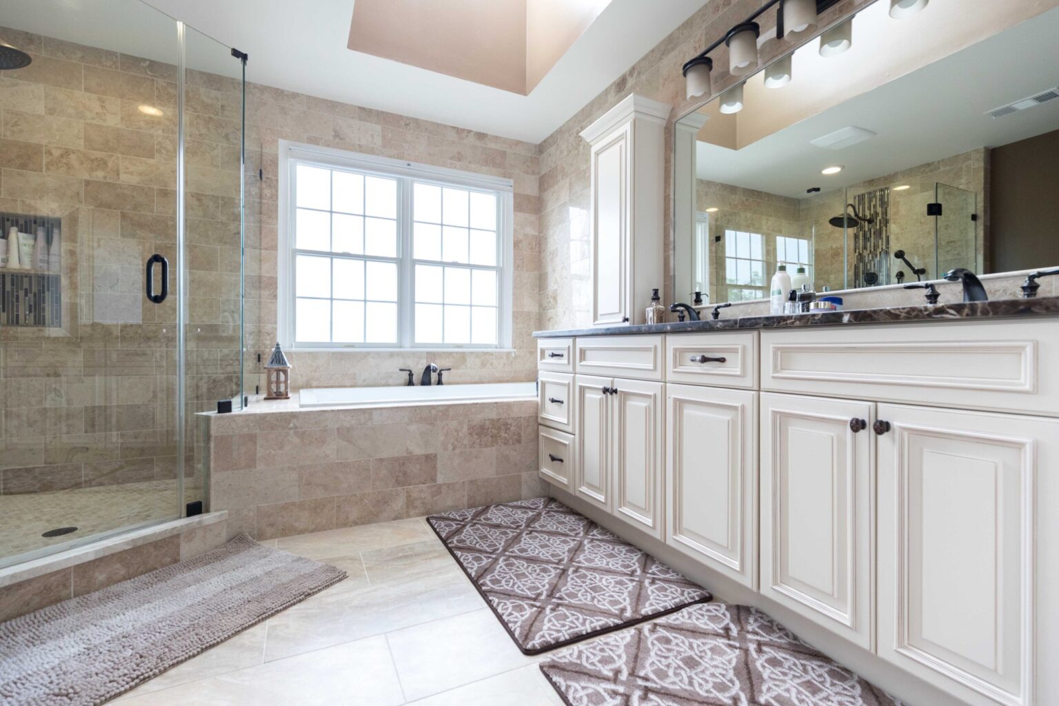 Traditional white bathroom vanity with soaking tub and glass shower