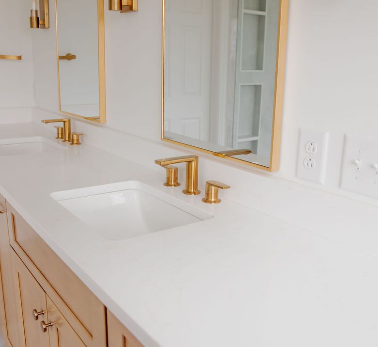 Quartz vanity top with undermount sink and brushed gold faucet