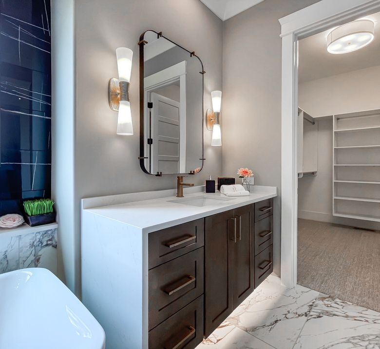 Custom bathroom vanity with marble countertop and arched mirror