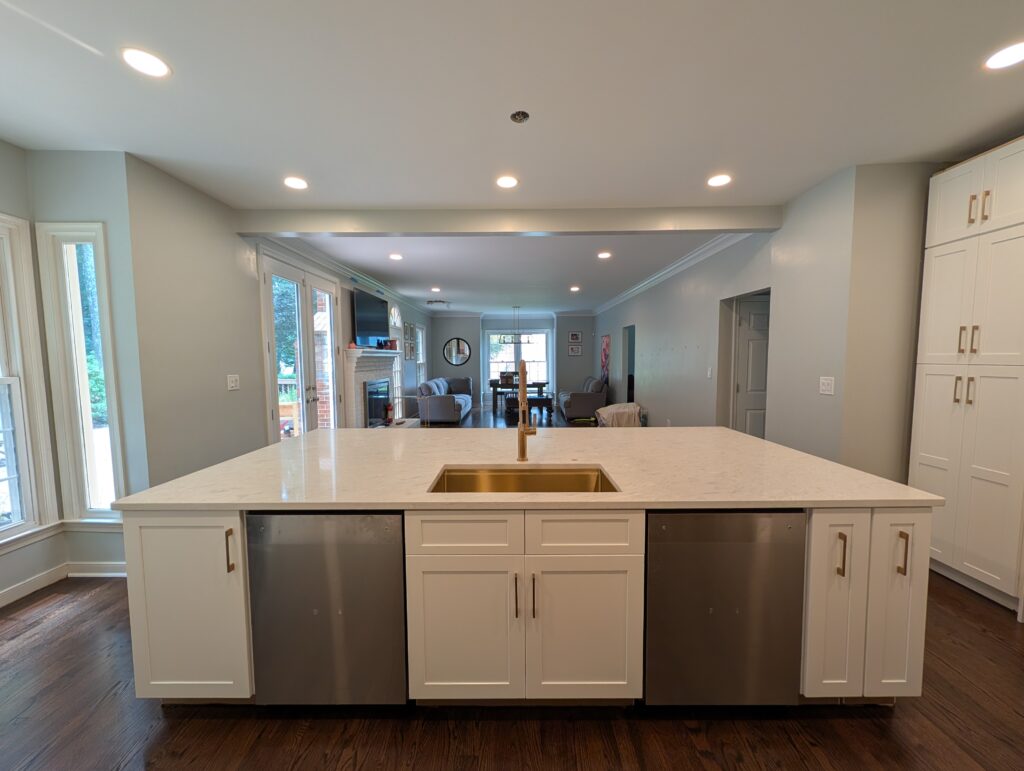 Quartz island with a brass undermount sink opening into the living room in a Rockville, MD kitchen