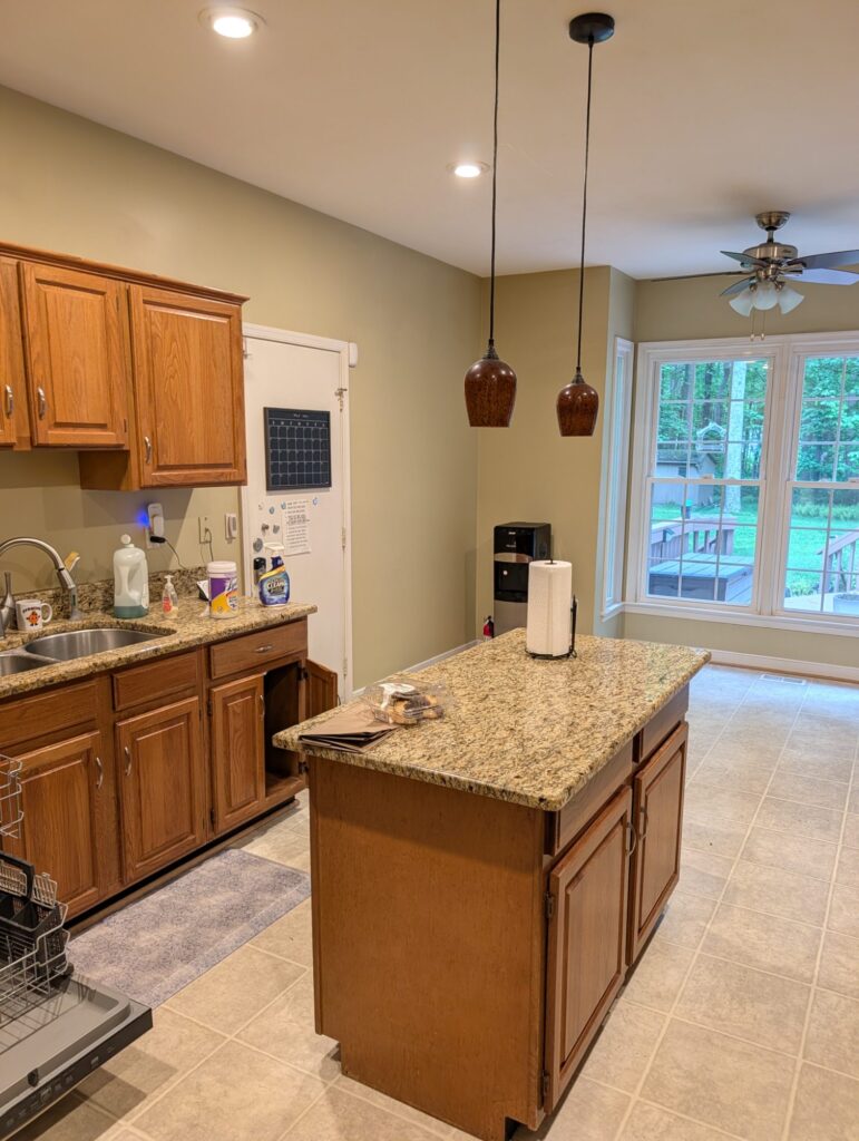 The small original island and oak sink run, looking toward the bay window and rear deck.